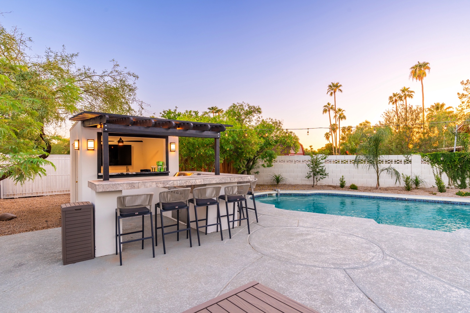 Sip sunset cocktails at your private poolside bar, then dive into refreshing waters surrounded by swaying palms and desert gardens—your own backyard oasis awaits.