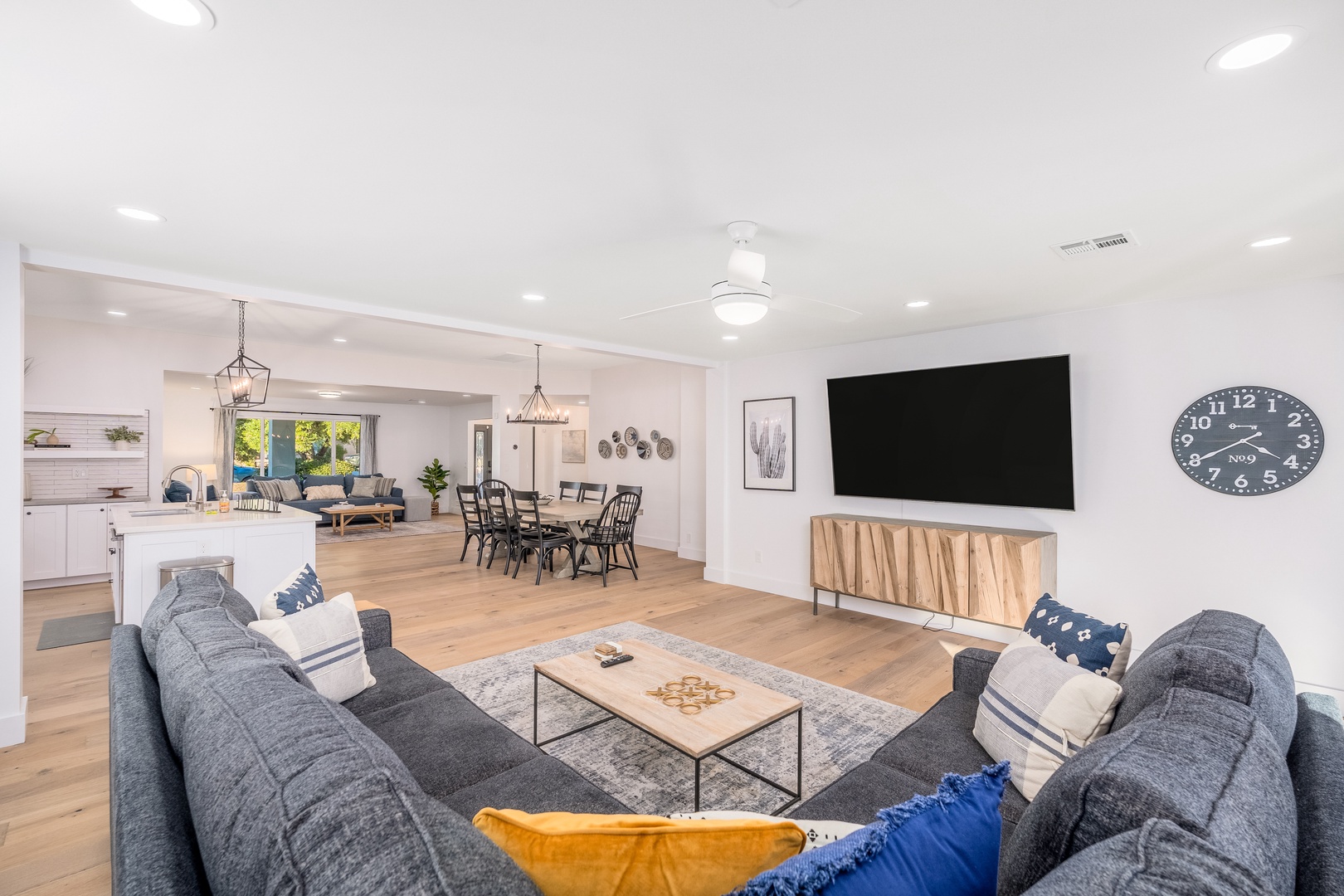 Step into your open-concept sanctuary where natural light and coastal charm meet modern comfort. Sink into plush seating, gather around the dining table, or unwind with your favorite show on the big screen.