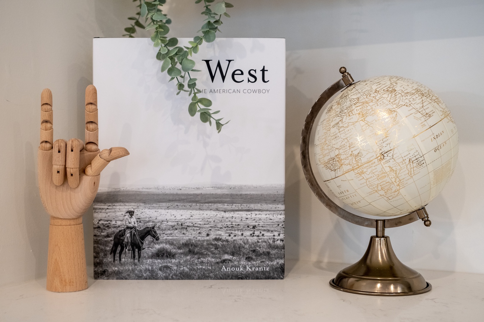 A curated shelf display featuring a vintage globe, stylish book, and decorative accents that add personality and charm to your living space.
