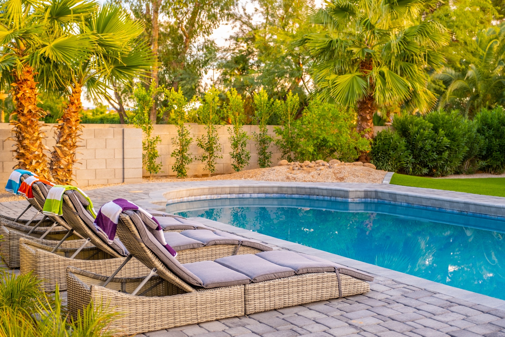 Imagine lounging poolside on cushioned chairs, towel in hand, surrounded by swaying palms and lush greenery. Your private oasis awaits, perfect for soaking up the sun and unwinding in serene comfort.