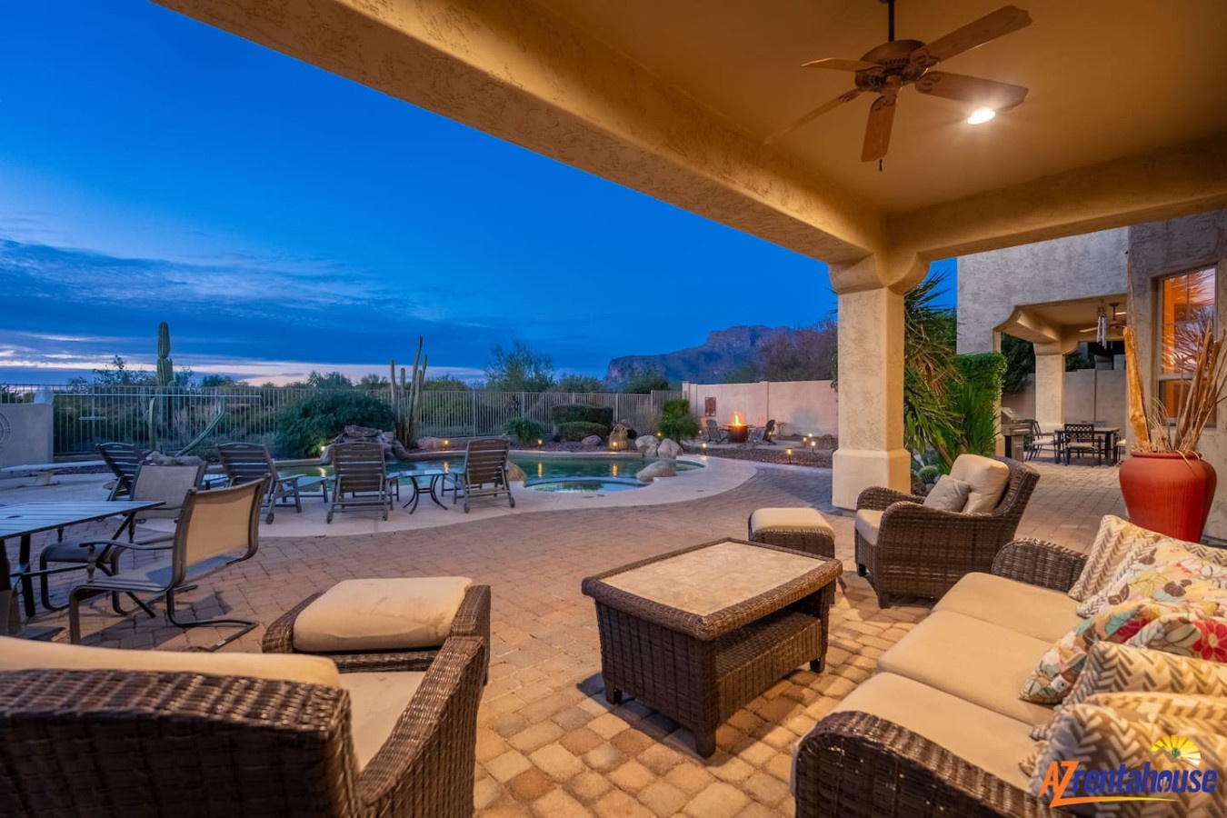 Relax on your private covered patio with desert mountain views and pool access at twilight.