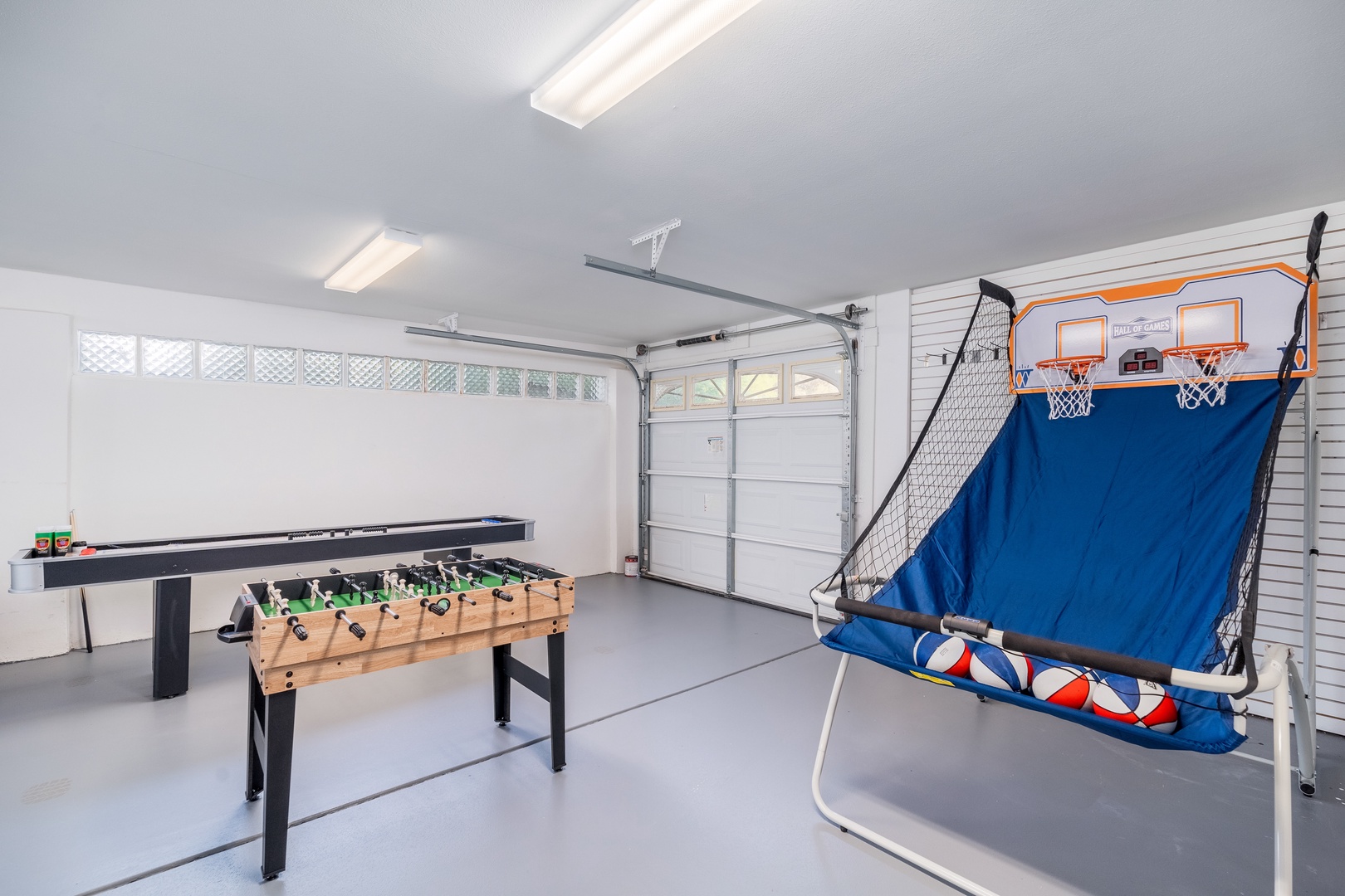 Challenge your friends and family to competitive fun in this bright game room, featuring foosball, basketball hoops, and air hockey—perfect for lively entertainment during your stay.