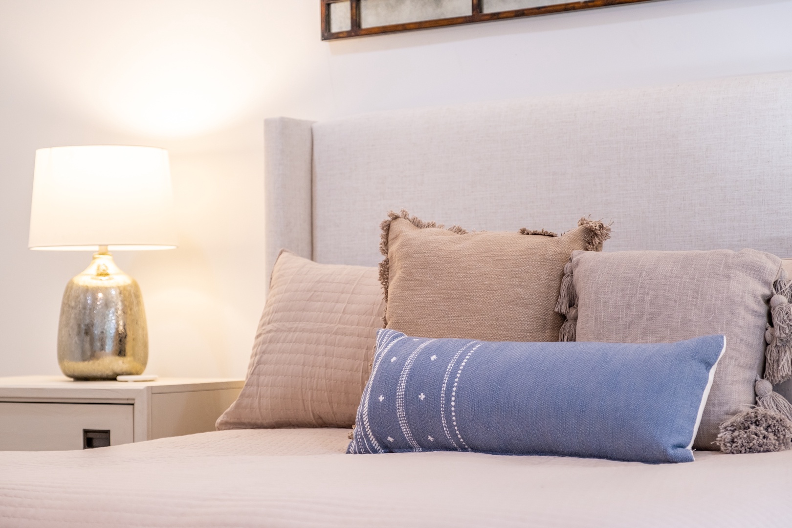 Sink into this plush bed after a day of exploring. Soft linens, layered pillows, and warm lighting create your perfect retreat for restful nights.