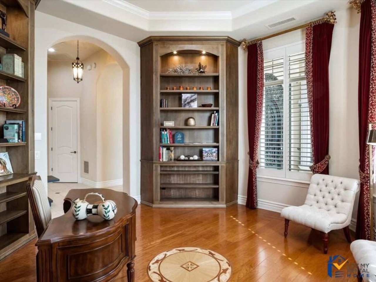 Your private home office awaits with rich wood finishes, custom built-ins, and elegant details perfect for productive work sessions.