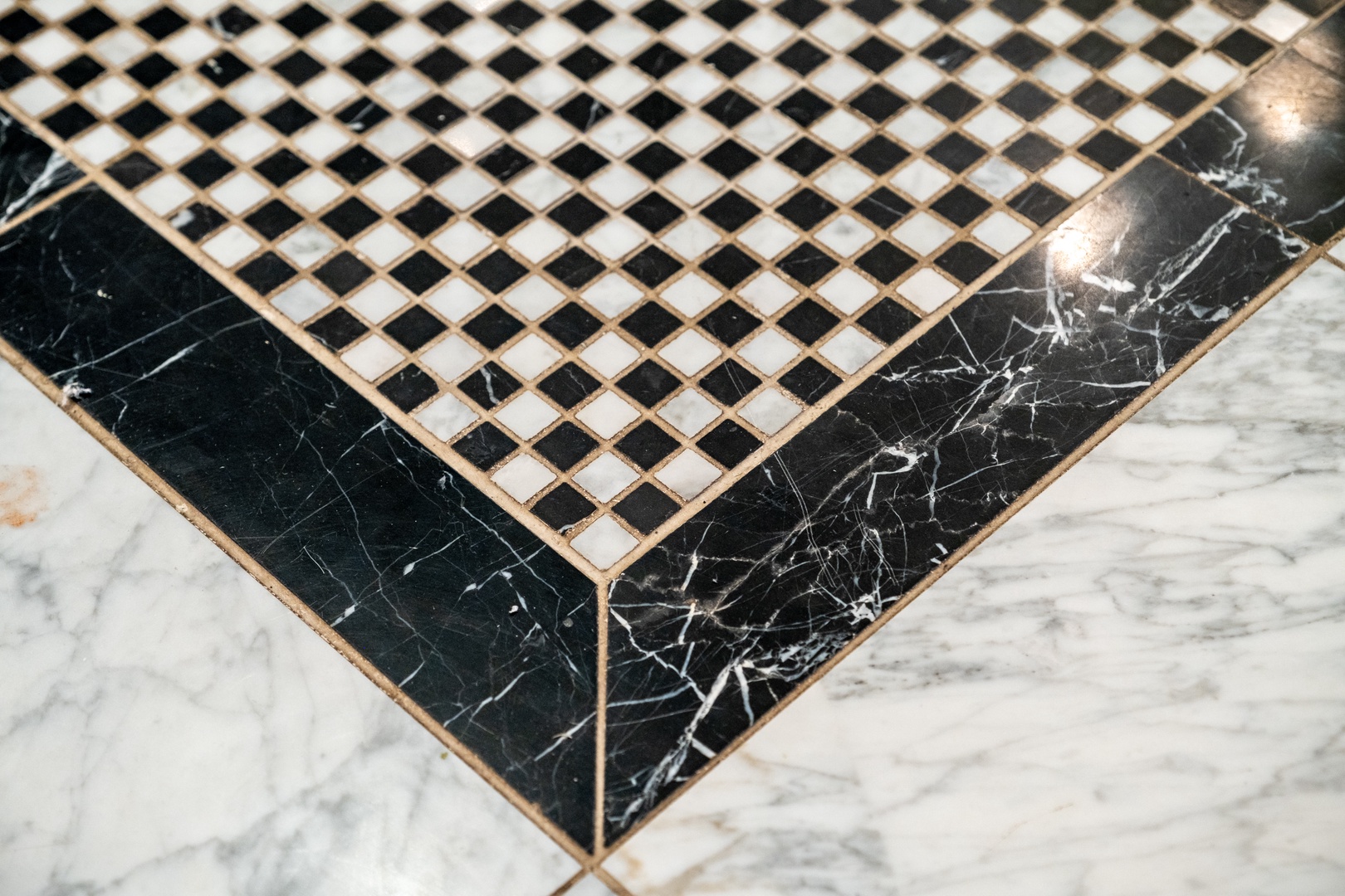 Elegant marble floor with black and white checkered tile detail adds classic sophistication to your stay.