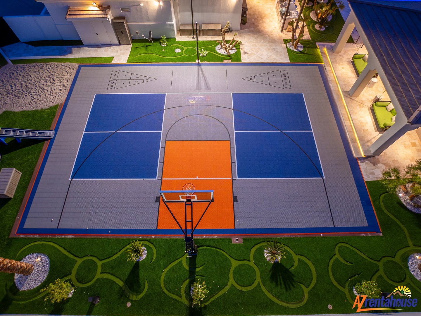 Aerial view showcasing the property's full-sized basketball court with professional markings and surrounding landscaped grounds.