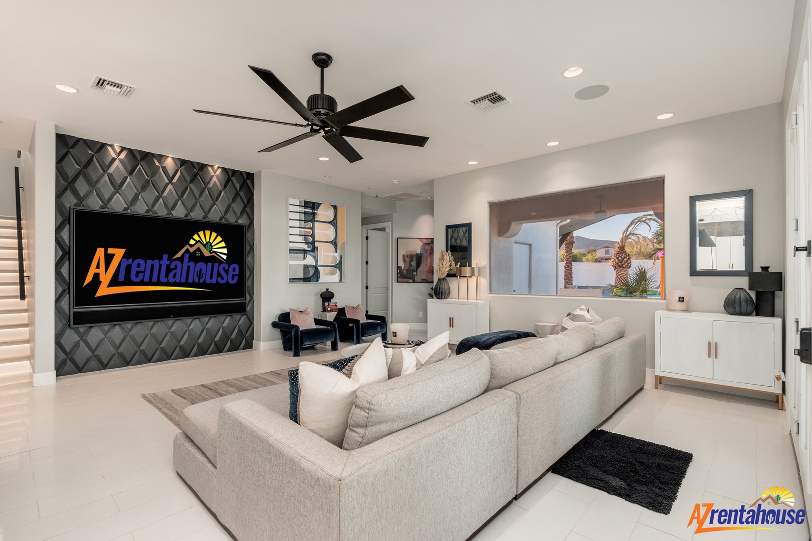 Unwind in your elegant living room featuring a stunning accent wall, plush sectional seating, and entertainment system—perfect for movie nights.