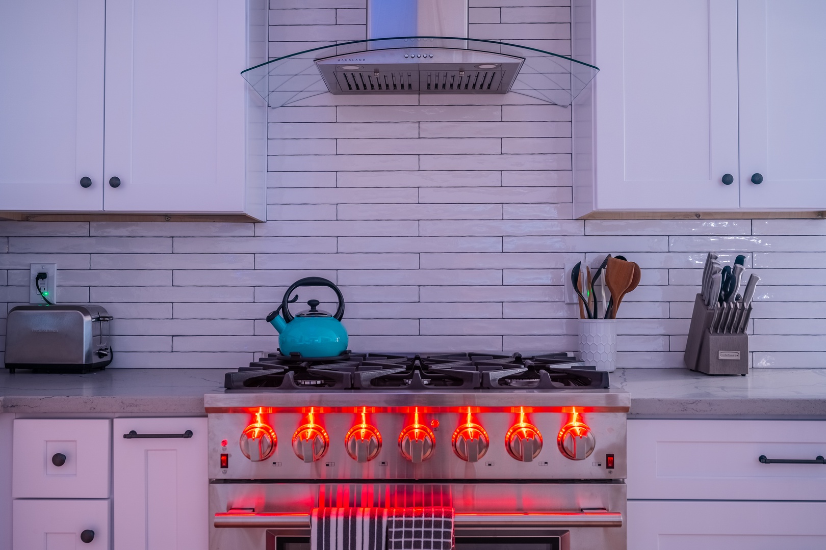 Sleek white subway tile backsplash and modern stainless steel appliances set the stage for your culinary adventures in this bright, chef-ready kitchen.
