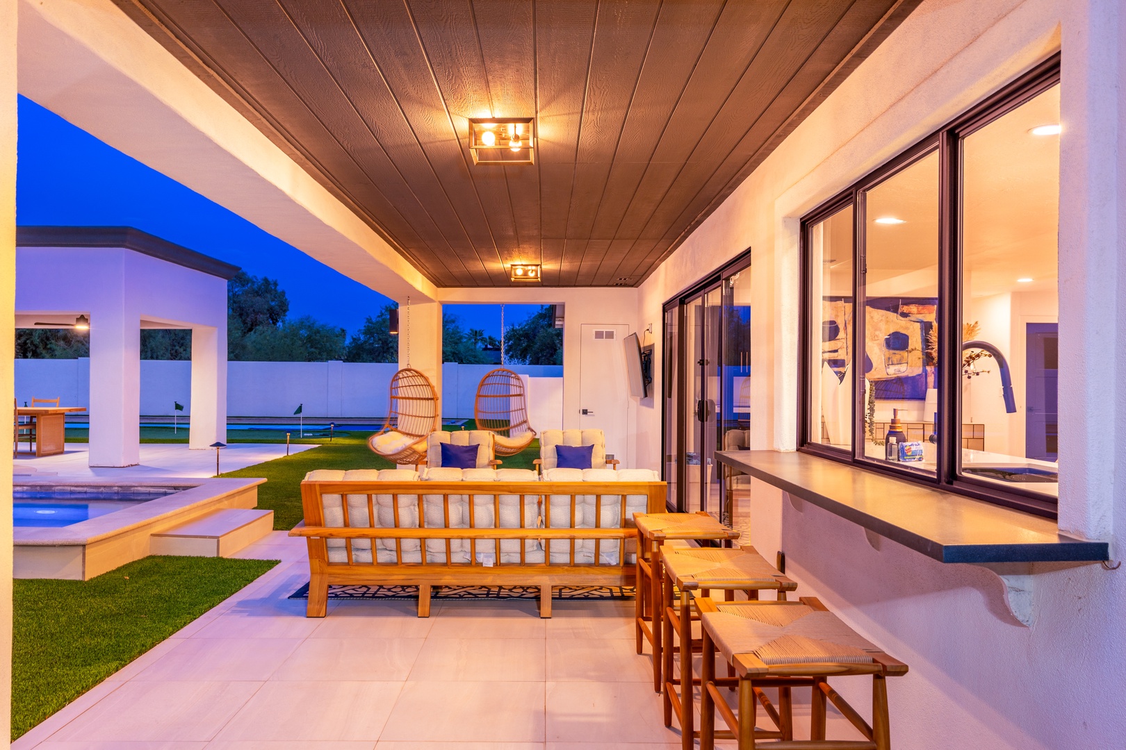This stunning covered patio is your personal outdoor living room, complete with stylish seating and warm lighting for unforgettable evenings under the stars.