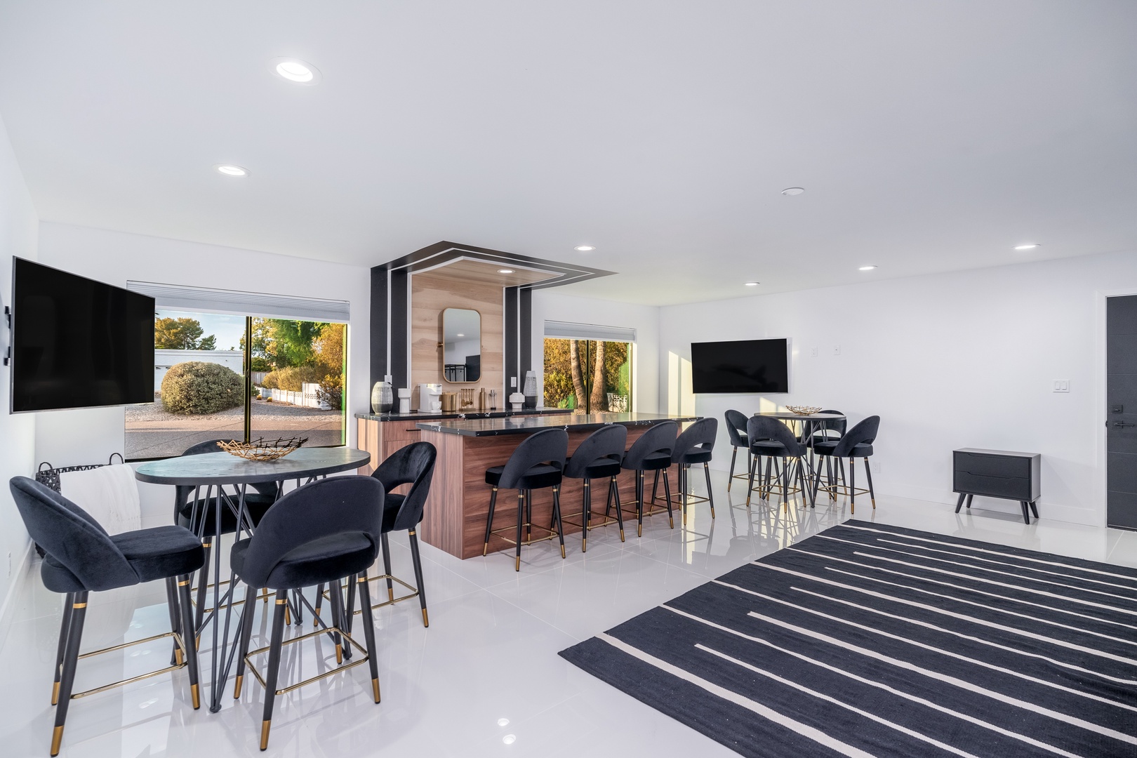 Step into your sleek social hub—gather at the bar with friends, enjoy a meal, or unwind with a movie while desert views frame your getaway.