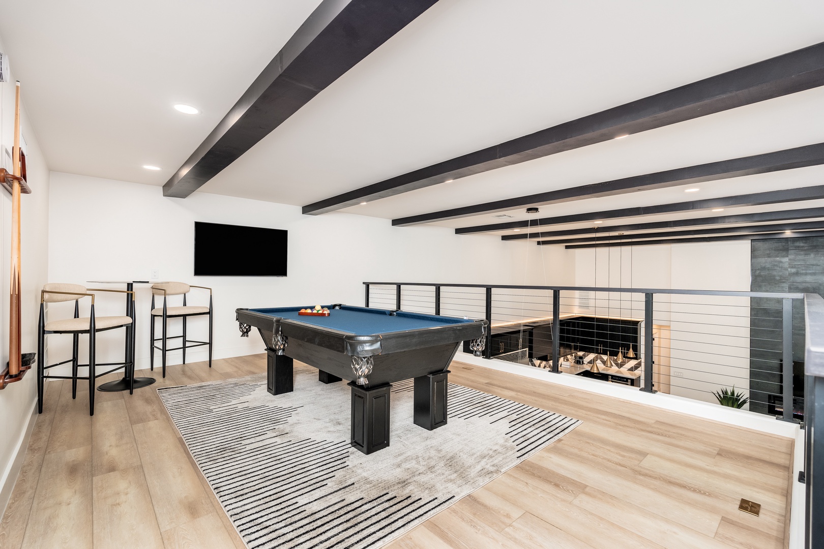 Challenge your group to a game on the sleek pool table, or relax in this stylish loft space featuring dramatic ceiling beams, high-top seating, and modern fireplace views.