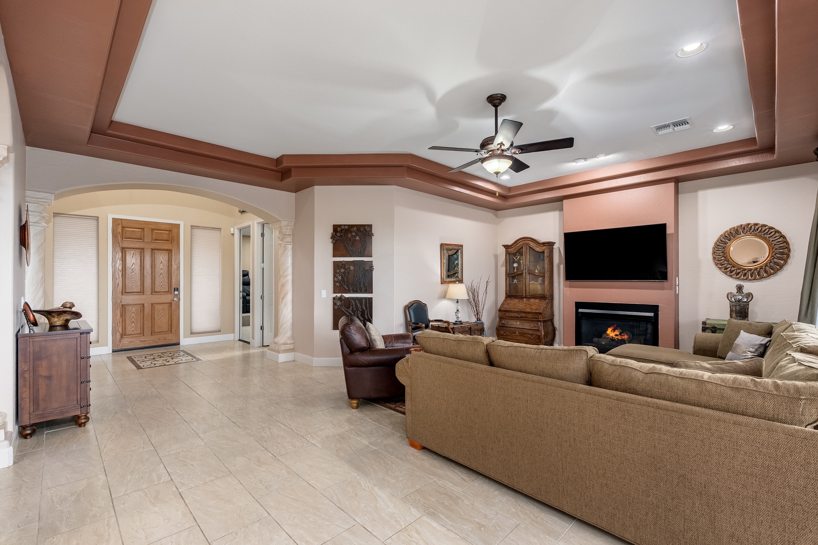 Relax in your spacious living room with soaring ceilings, a cozy fireplace, and inviting furnishings that make every evening feel special.
