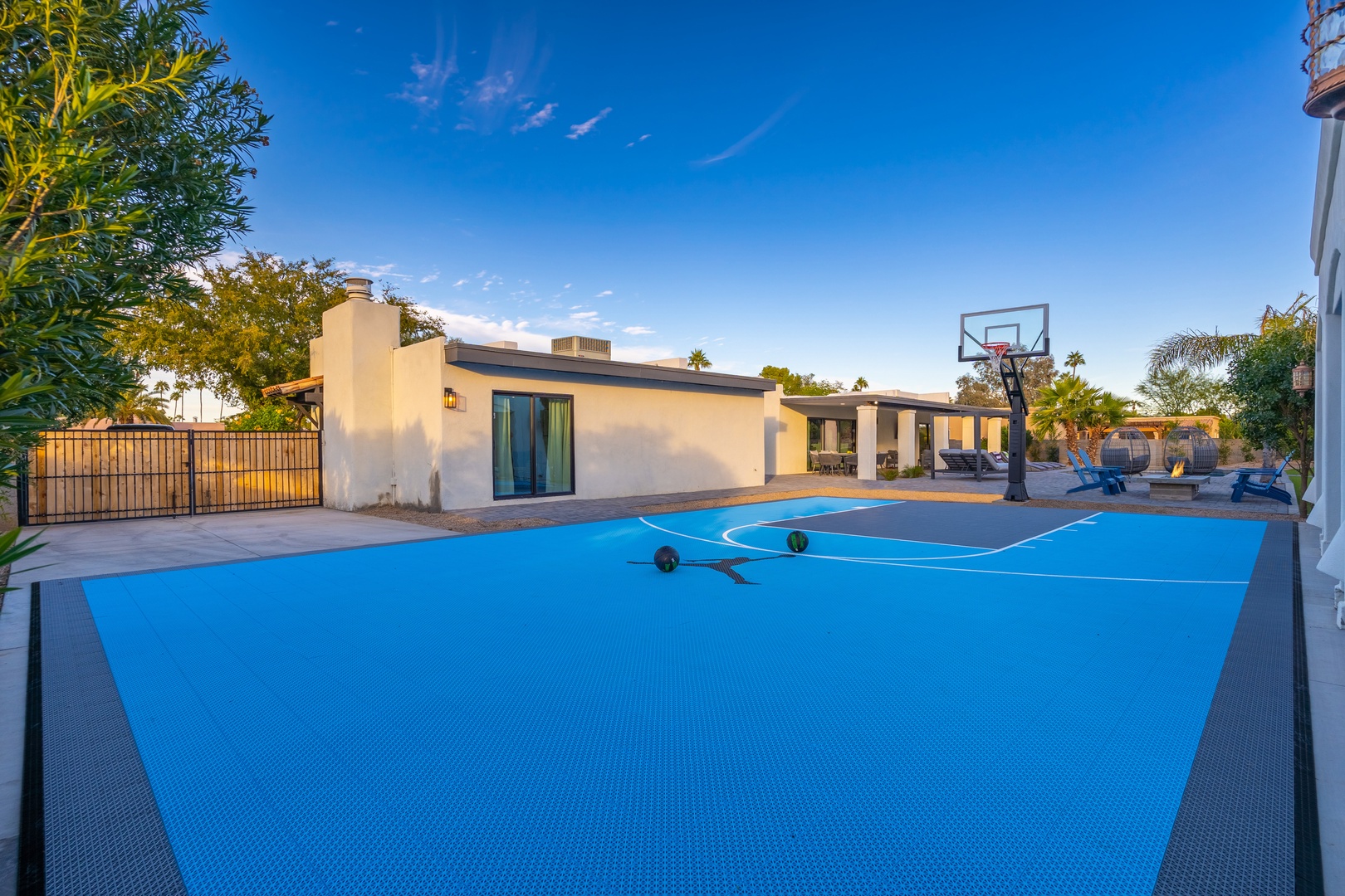 Spacious private basketball court with regulation hoop and clear desert skies, ideal for friendly games and outdoor recreation under warm Arizona sunshine.