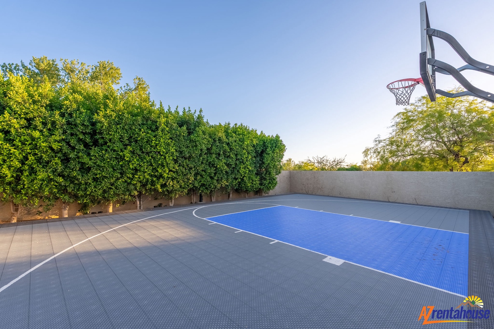 Challenge friends to a game on your private outdoor basketball court, surrounded by lush trees and open sky—perfect for active mornings and friendly competition.