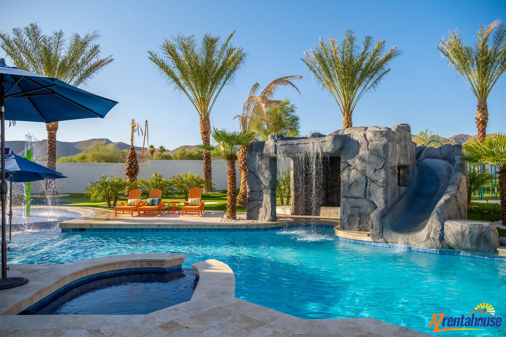 Dive into your private oasis featuring a stunning rock waterfall, slide, and spa surrounded by swaying palms.