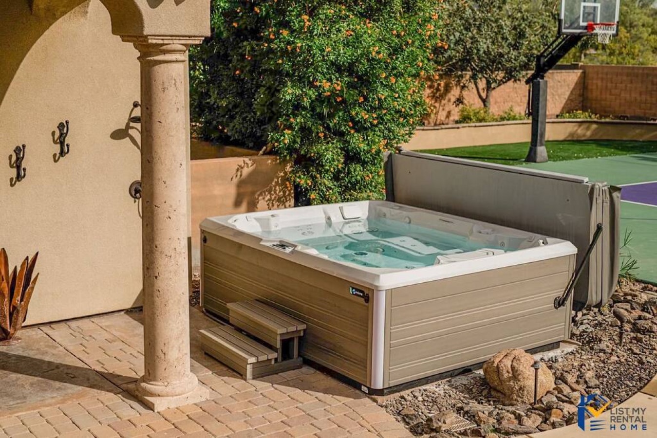 Soak your worries away in your private hot tub, nestled under peaceful archways with orange trees and recreational spaces nearby.