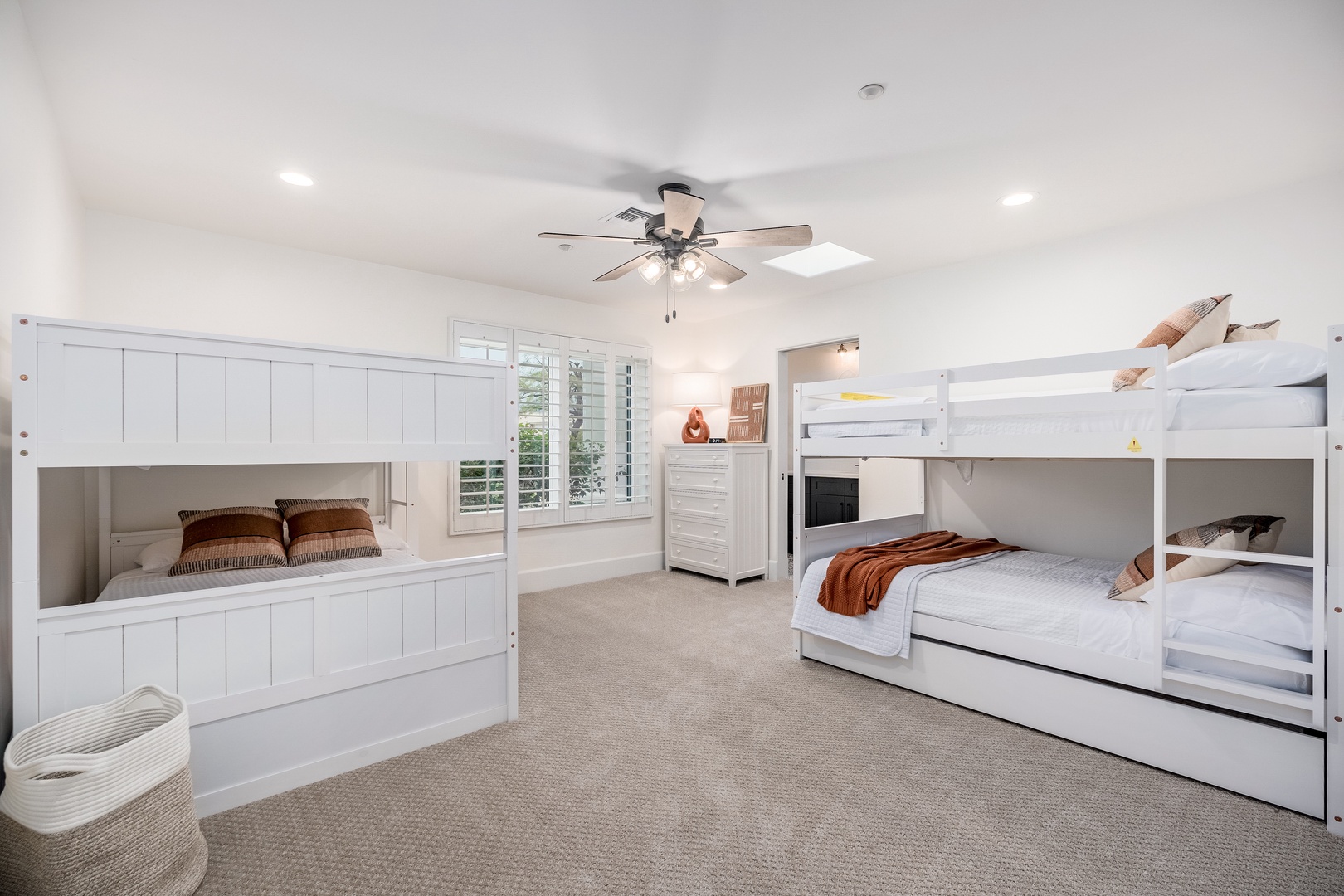 Spacious, bright bedroom with bunk beds perfect for family gatherings. Your group will love the cozy sleeping arrangements and natural light streaming through plantation shutters.
