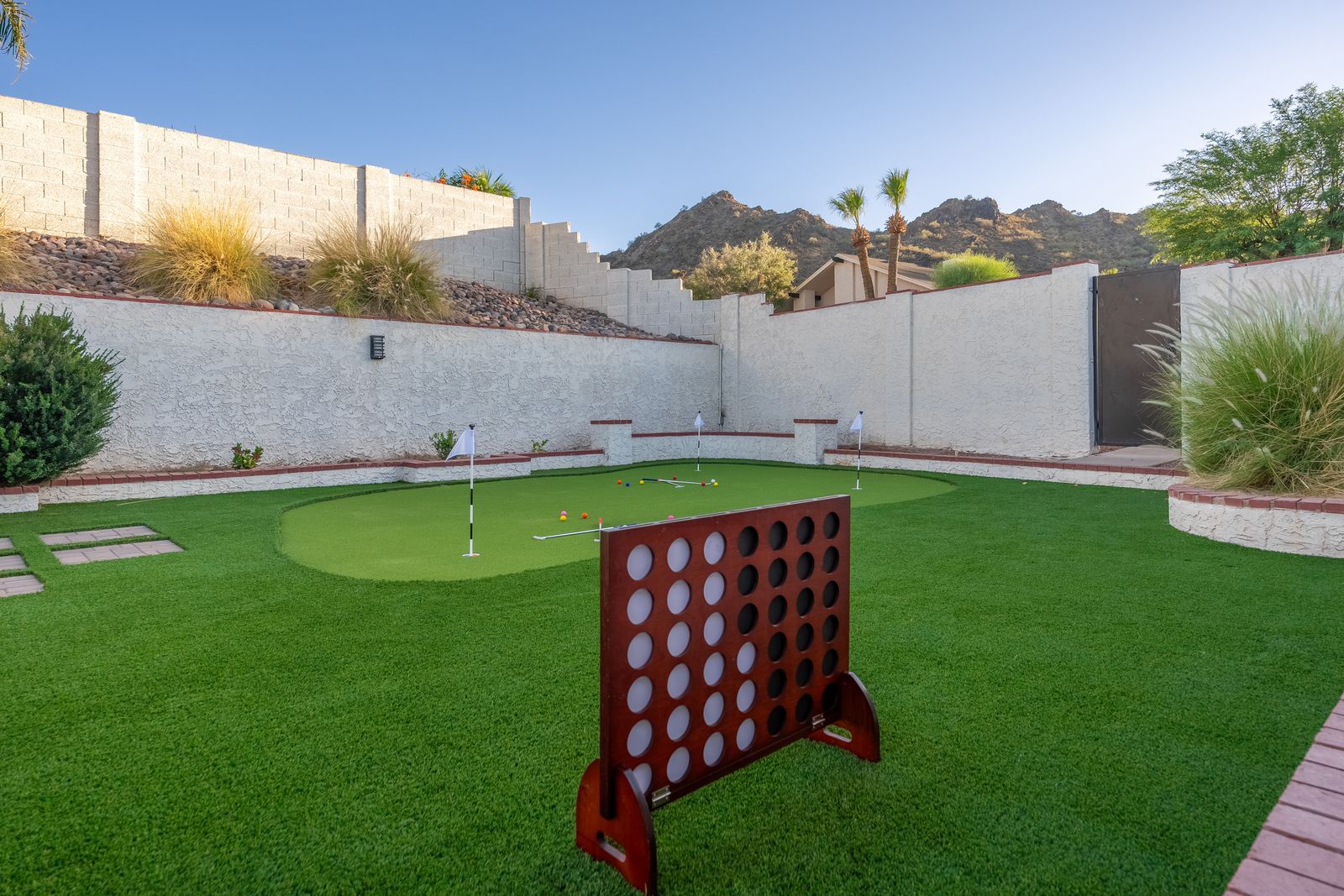 Your private play area offers miniature golf and yard games framed by desert mountain views—perfect for friendly competition and outdoor fun in the sunshine.