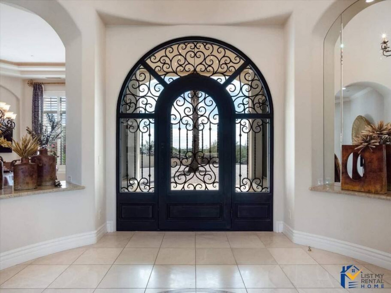 Step into elegance through this stunning arched entrance featuring ornate ironwork that frames your grand arrival.