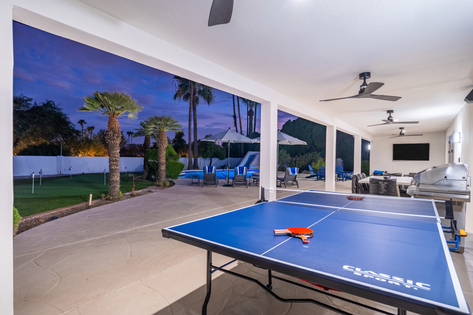 Challenge friends to table tennis under the covered patio, then step outside to your private pool framed by swaying palms and lush desert landscaping.
