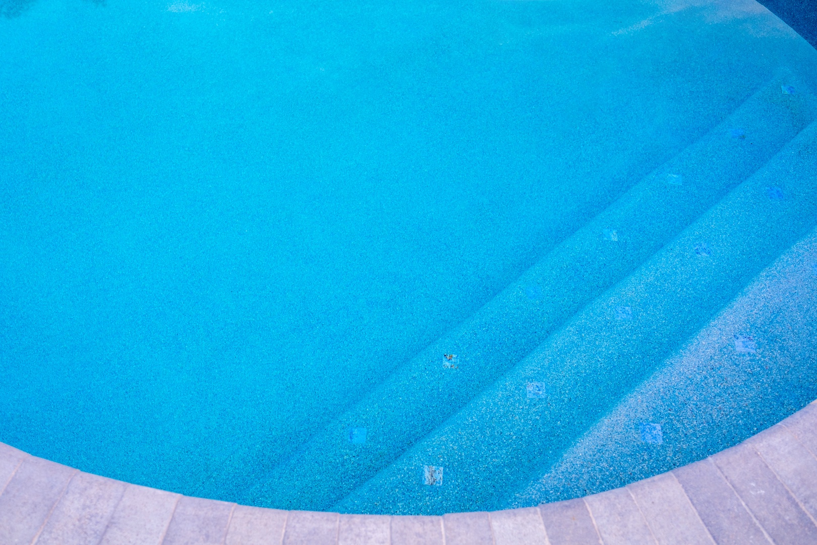 Dive into crystal-clear turquoise waters where relaxation awaits. Your private oasis features shallow entry steps perfect for leisurely dips and sun-soaked afternoons.