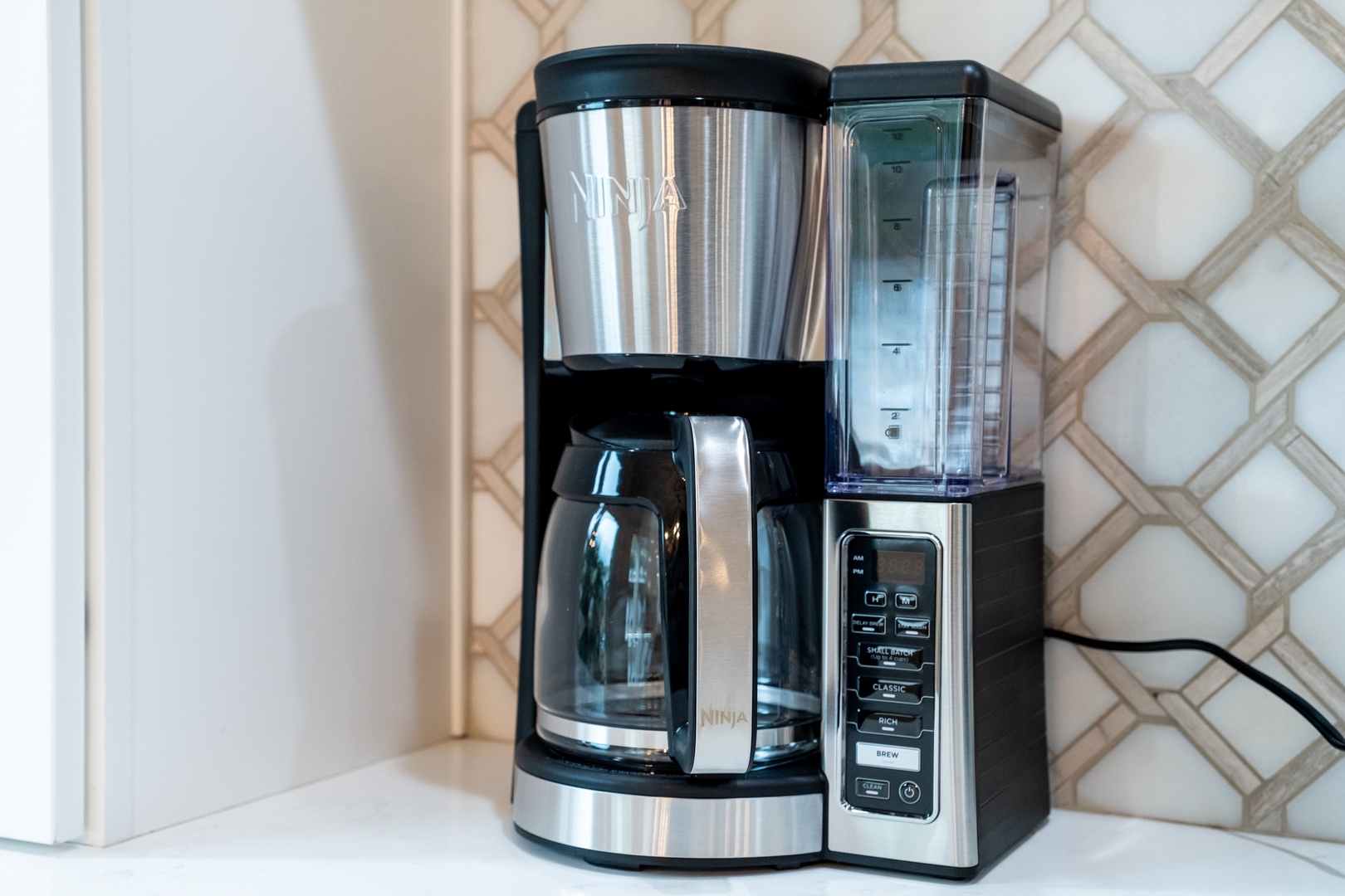 Start your mornings right with a sleek coffee maker and blender ready at your fingertips—perfect for brewing fresh coffee or blending smoothies as you settle in.