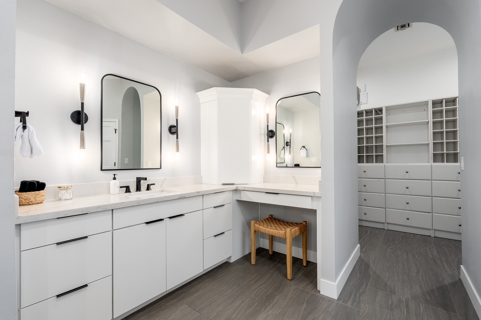 Your private bathroom features a spacious dual-vanity area with elegant marble countertops, perfect for getting ready each morning. A dedicated vanity nook and custom closet storage keep everything organized during your stay.