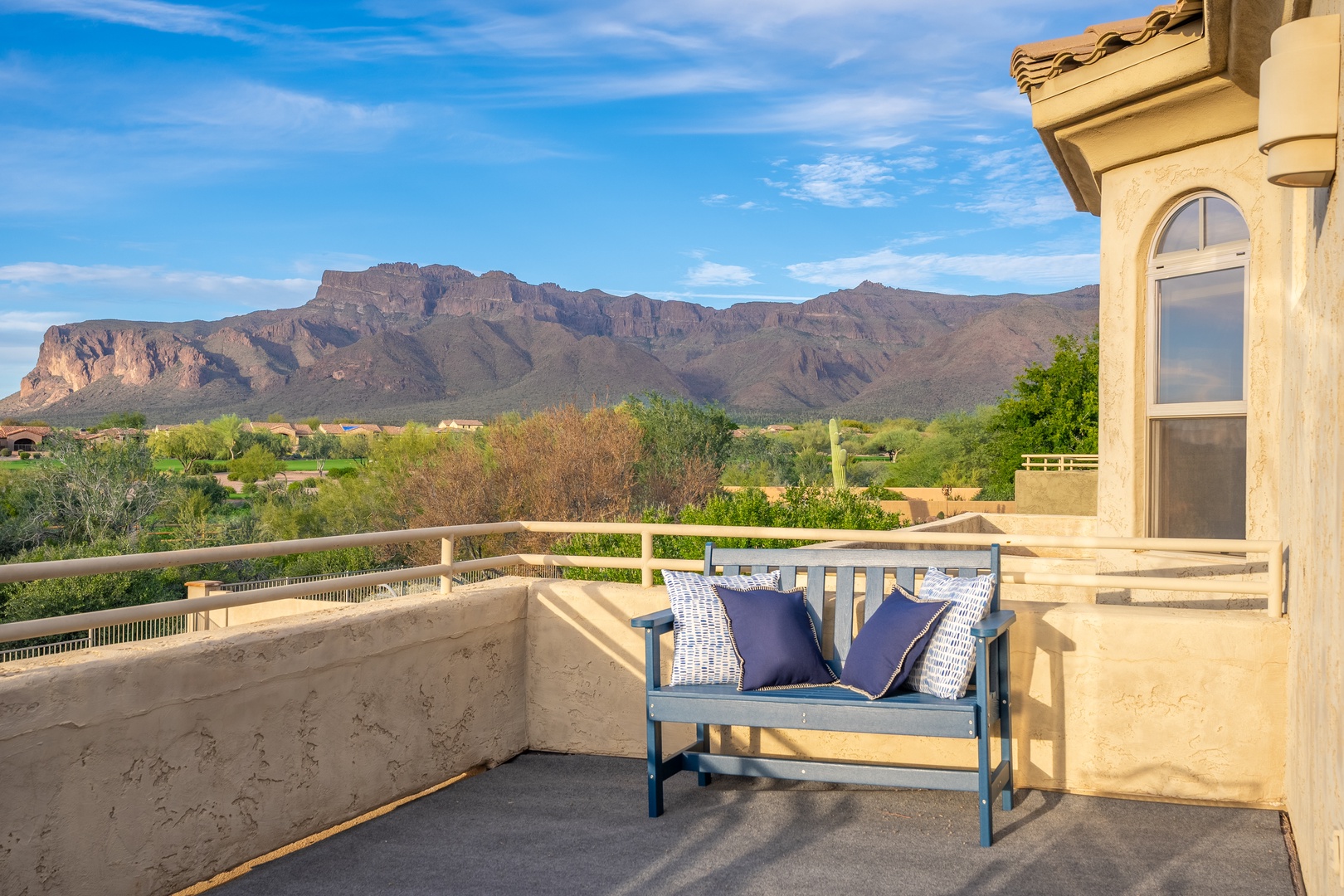 Sweeping desert mountain views from this private balcony, where a cozy bench awaits for peaceful mornings and sunset evenings in the heart of Arizona.