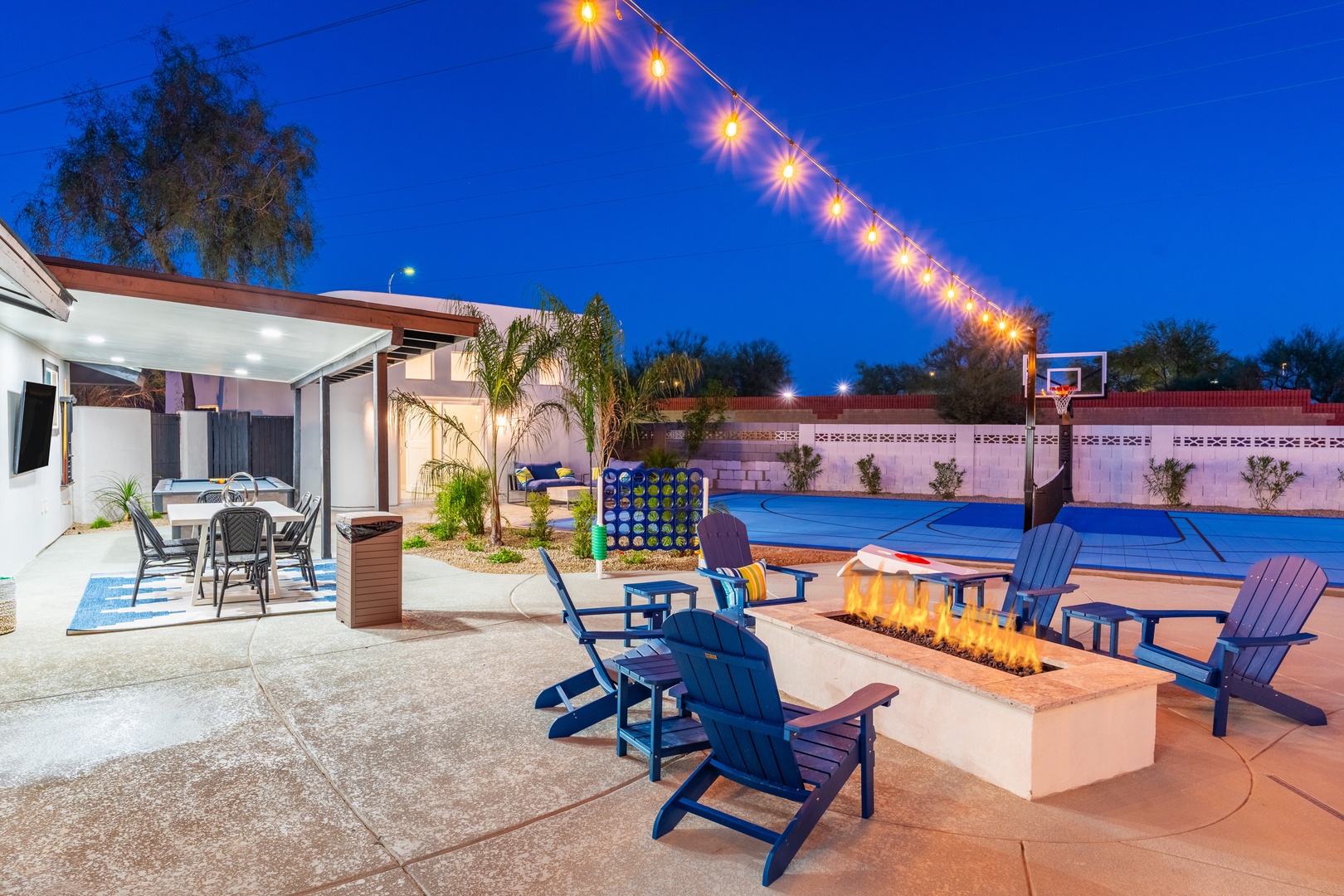 Picture yourself gathered around the modern fire pit as string lights glow overhead, creating the perfect setting for evening conversations and s'mores under the stars.