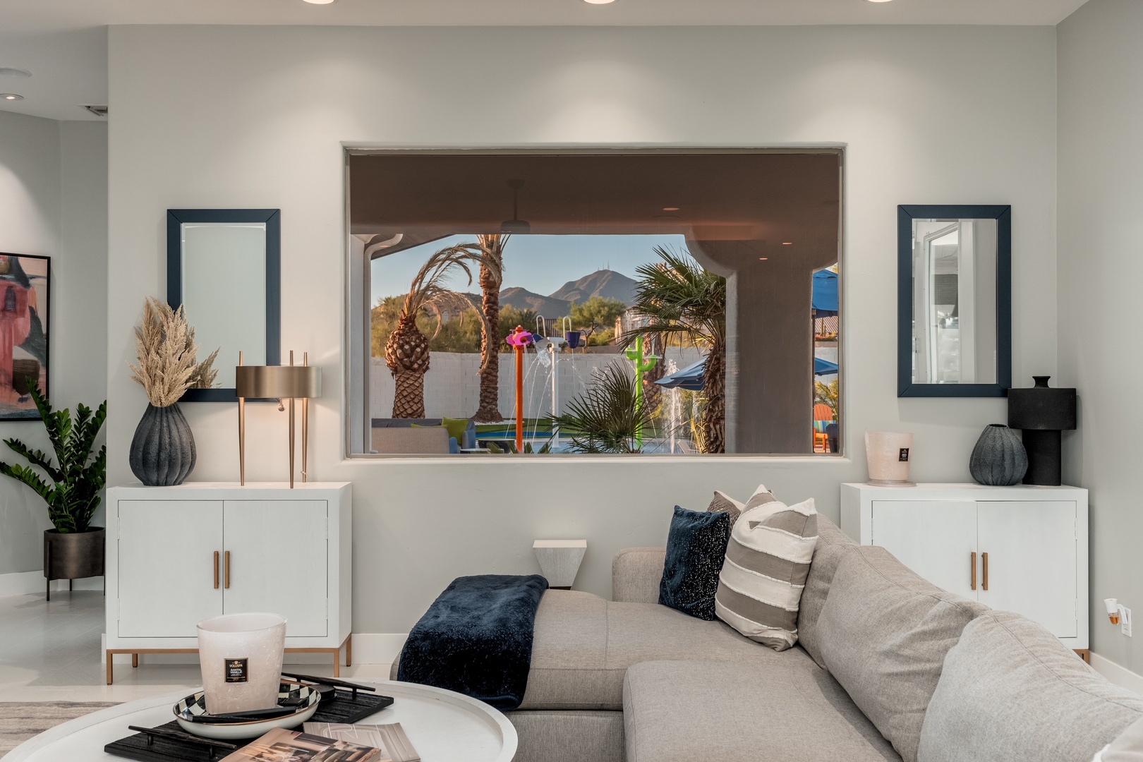 Sink into the plush sofa and take in mountain views framed by desert palms—your bright, modern retreat awaits with thoughtful touches and serene style.