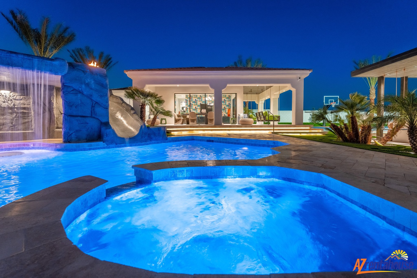 Modern luxury villa showcasing illuminated pool area and contemporary architecture during twilight hours.