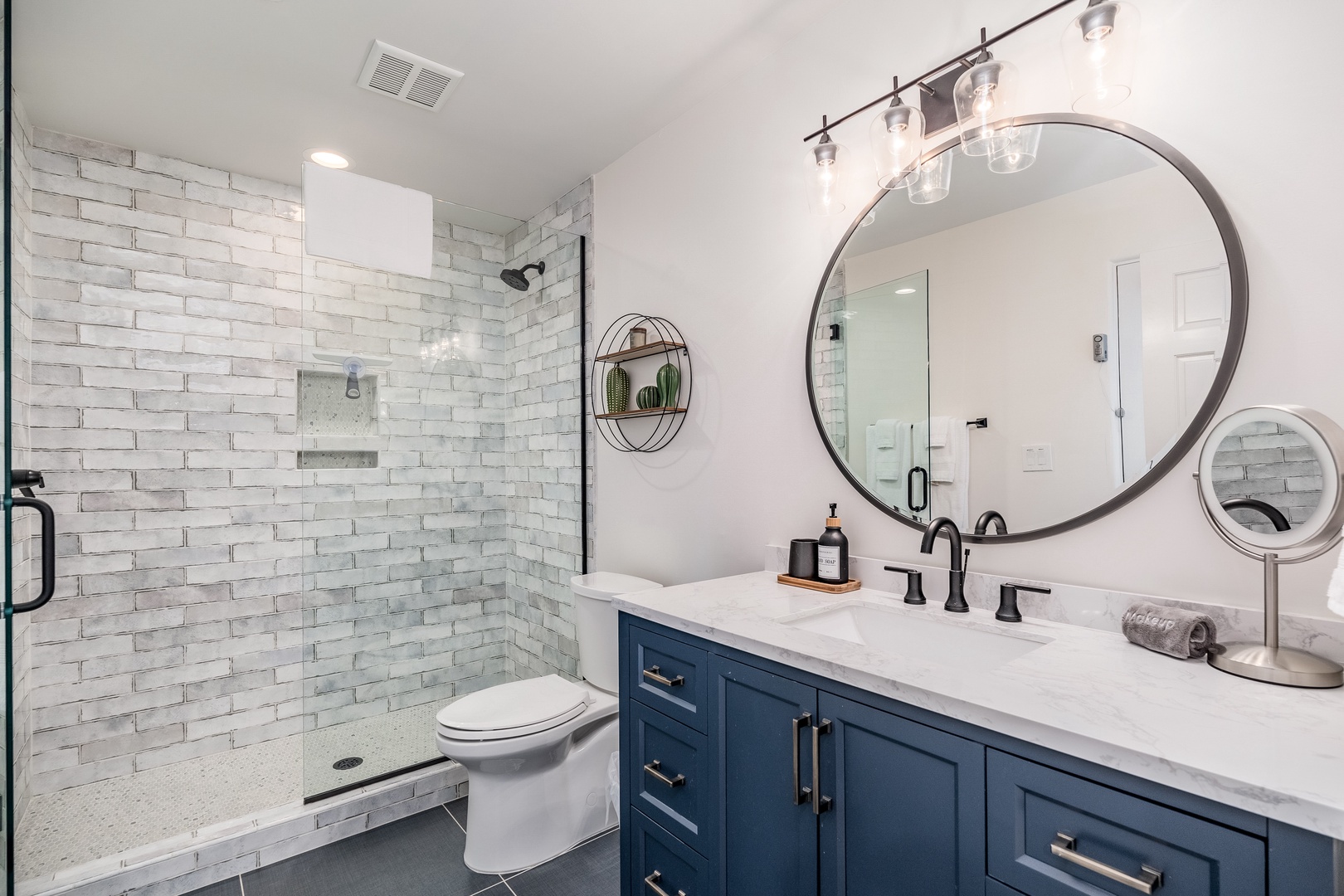 Refresh in this stunning bathroom featuring a spacious walk-in shower, elegant subway tile, and a sleek vanity with modern fixtures—your private retreat awaits.