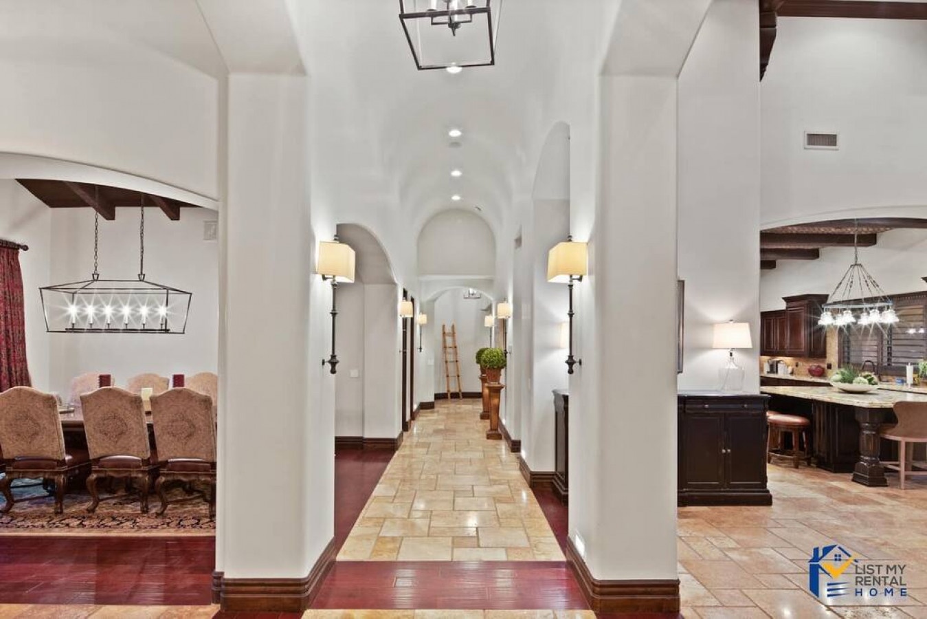 Step into your elegant hallway where warm lighting and arched doorways create a welcoming flow between your spacious dining and kitchen areas.