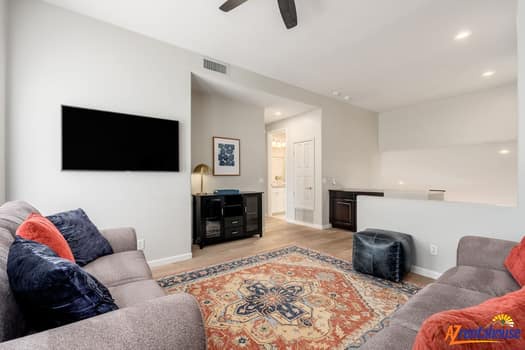 Settle into your comfortable living space with plush seating and entertainment center for perfect evening relaxation.