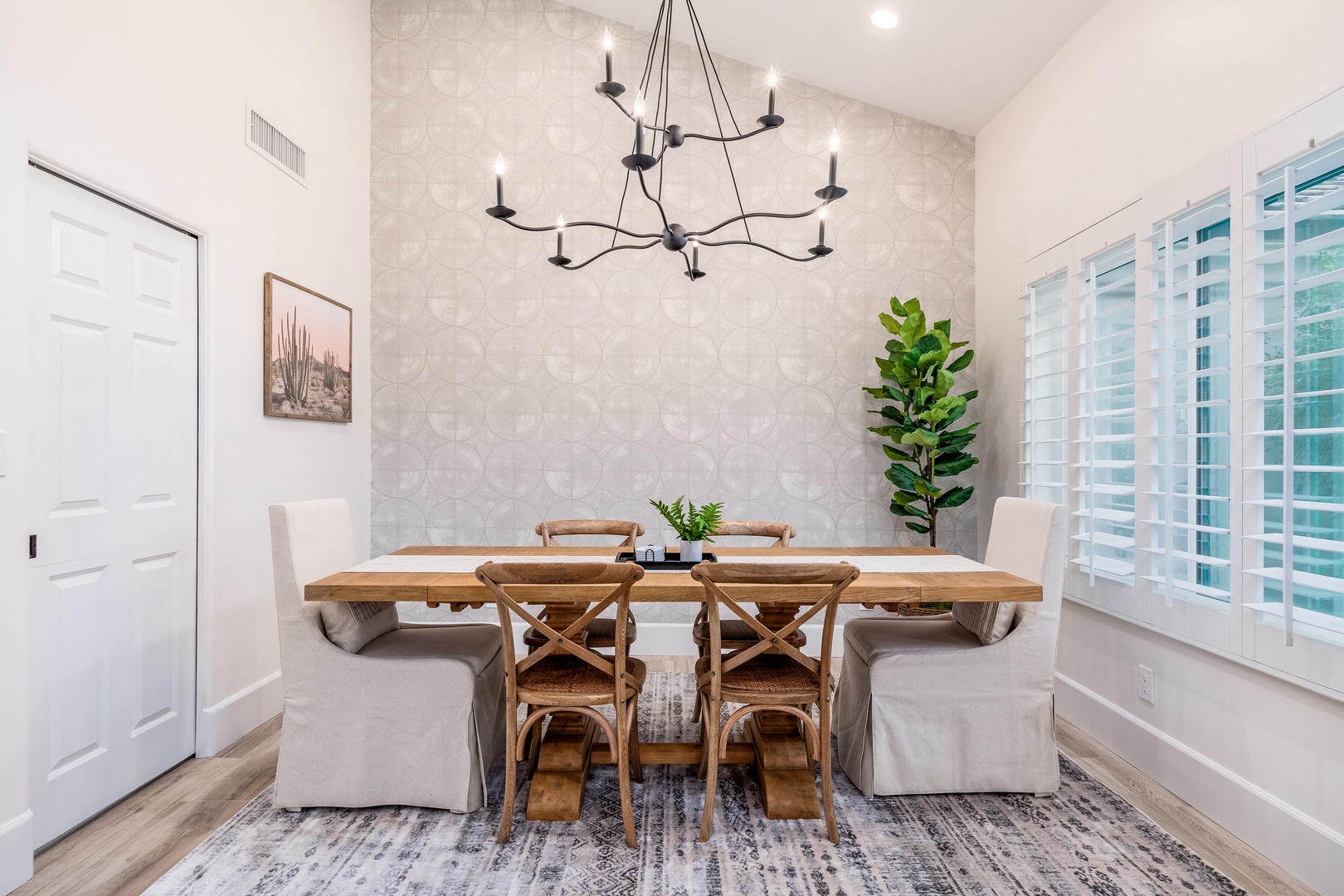 Gather around this inviting farmhouse table for meals that feel like home. With comfortable seating and natural light streaming through the shutters, your mornings and evenings here will be effortlessly warm and welcoming.