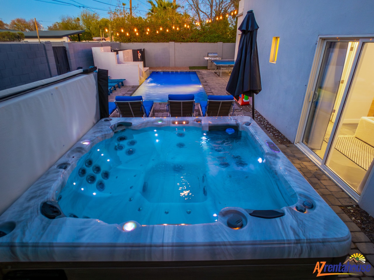 Unwind in your private hot tub under twinkling lights, then take a dip in the inviting pool just steps away.