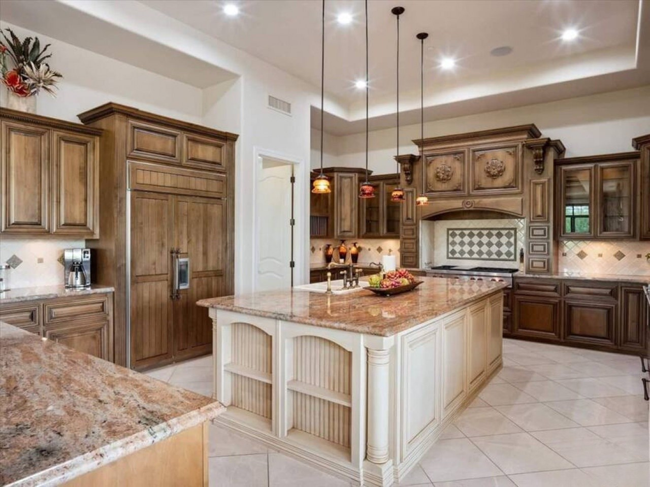Imagine preparing meals in this spacious gourmet kitchen with elegant granite countertops, custom wood cabinetry, and a grand center island—perfect for cooking and gathering with loved ones.