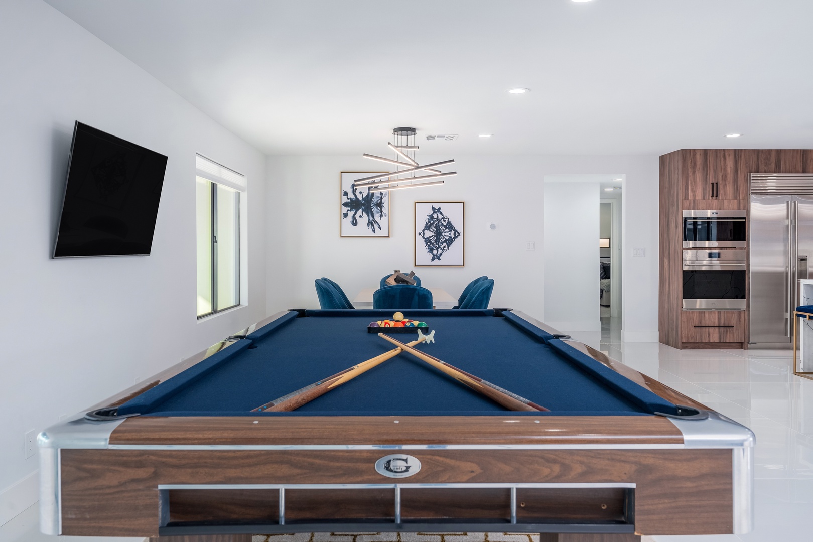 Challenge your friends to a game on the sleek pool table, then gather around the stylish dining area for your next meal together in this bright, modern space.