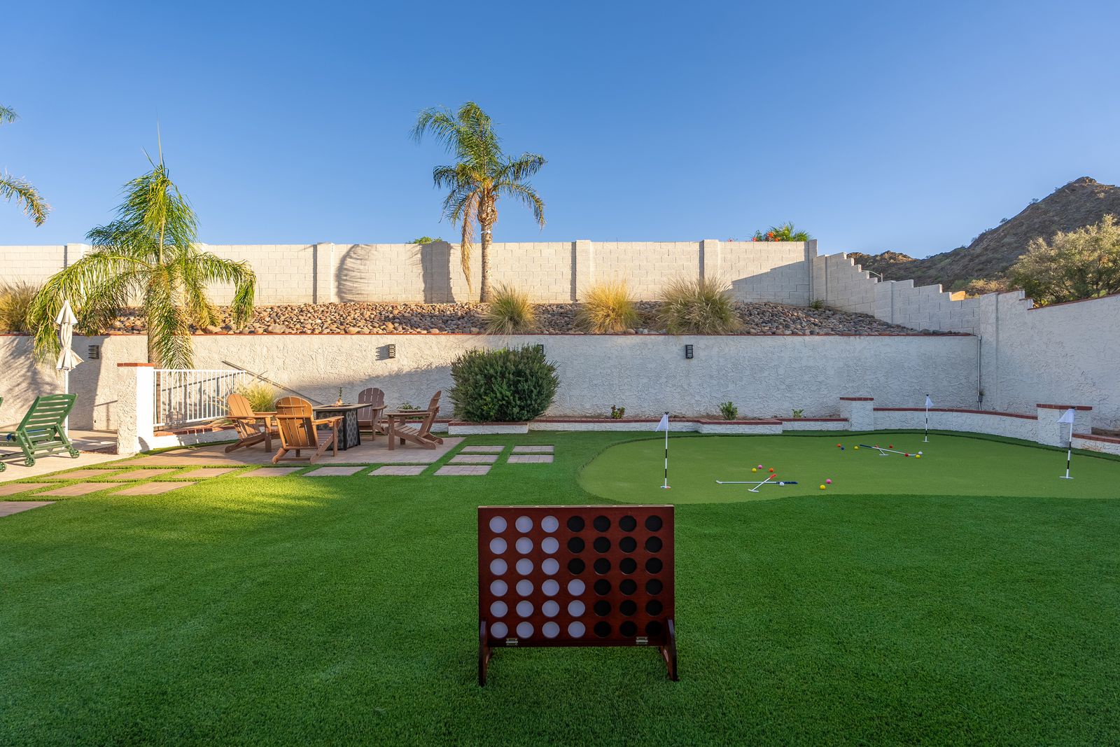 Challenge your friends to putting practice or a giant game of connect-four in your private backyard oasis, complete with artificial turf, mountain views, and inviting fire pit seating.