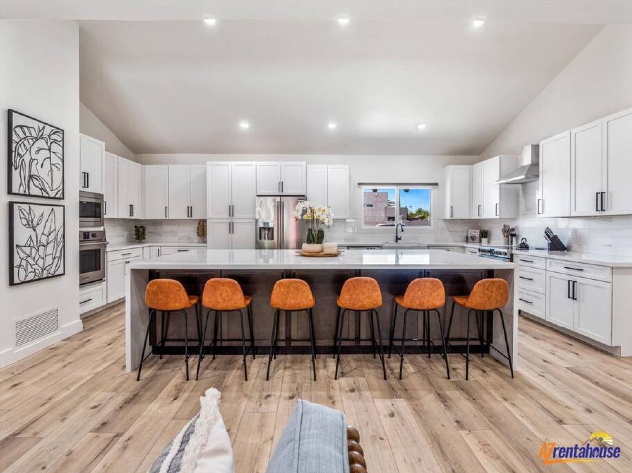 Cook together in this stunning modern kitchen with gleaming countertops, premium appliances, and cozy bar seating for six.