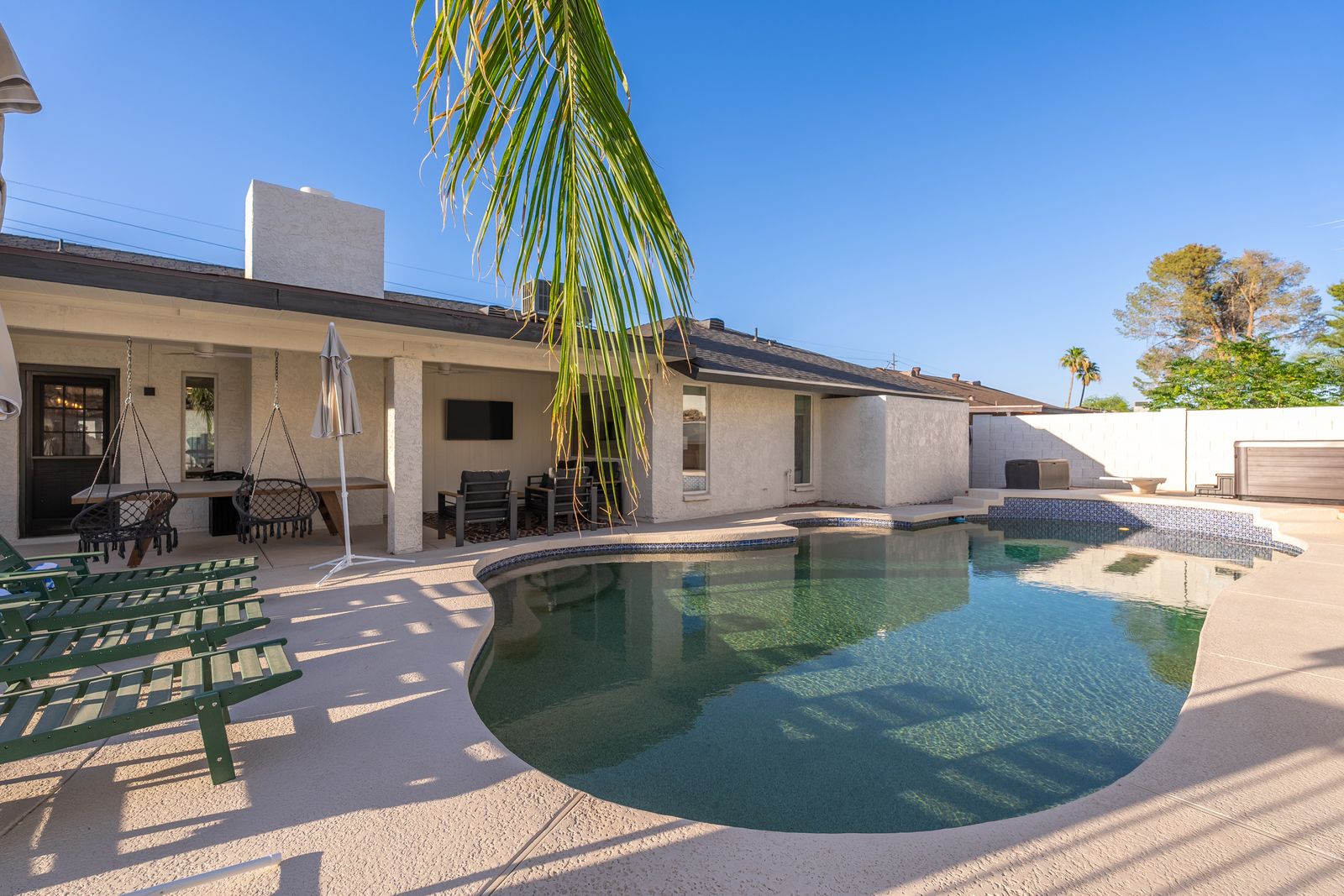 Lounge by your private pool under swaying palms, relax in the hammock swing, or dine outdoors with scenic desert views—this spacious backyard oasis is all yours to enjoy.