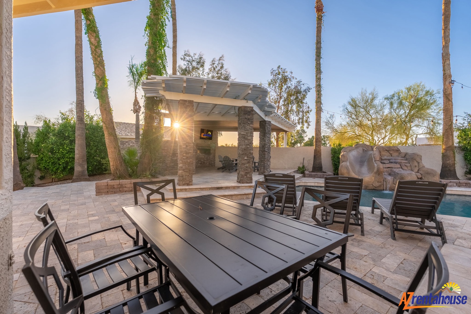 Bask in Arizona sunshine at your private outdoor haven—featuring resort-style dining, a covered pergola, sparkling pool, and surrounded by swaying palms for effortless desert relaxation.