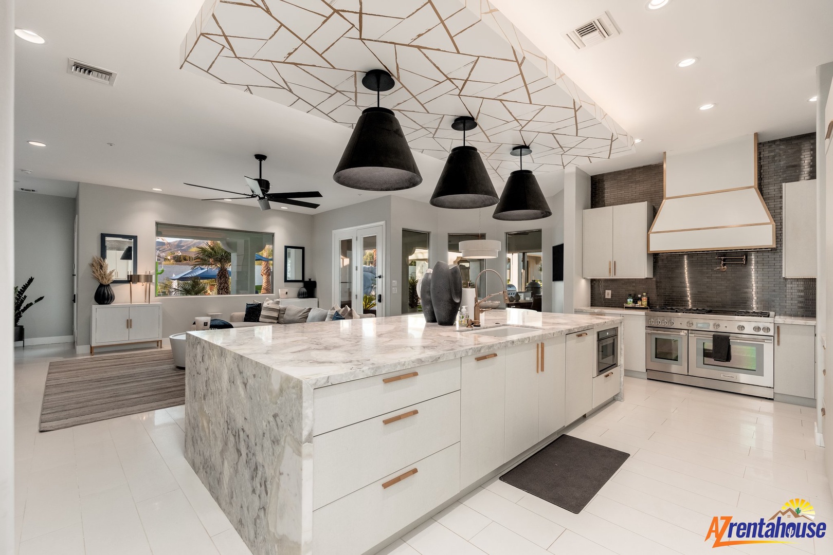 Your stunning kitchen beckons with gleaming marble countertops, professional-grade appliances, and striking geometric ceiling details that create an inspiring culinary sanctuary.