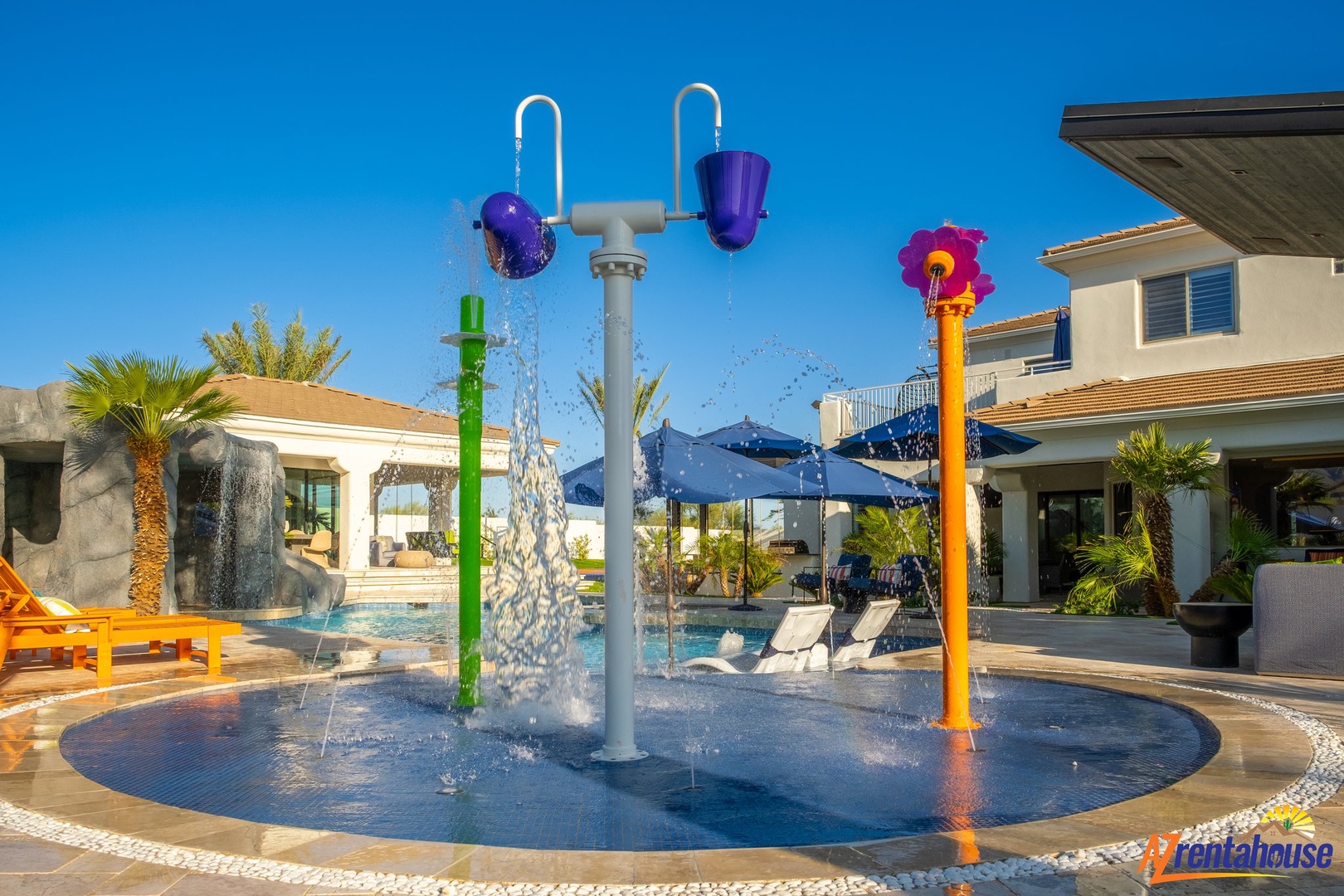 Colorful splash zone with tipping buckets creates endless fun for your little ones in this family-friendly pool area.