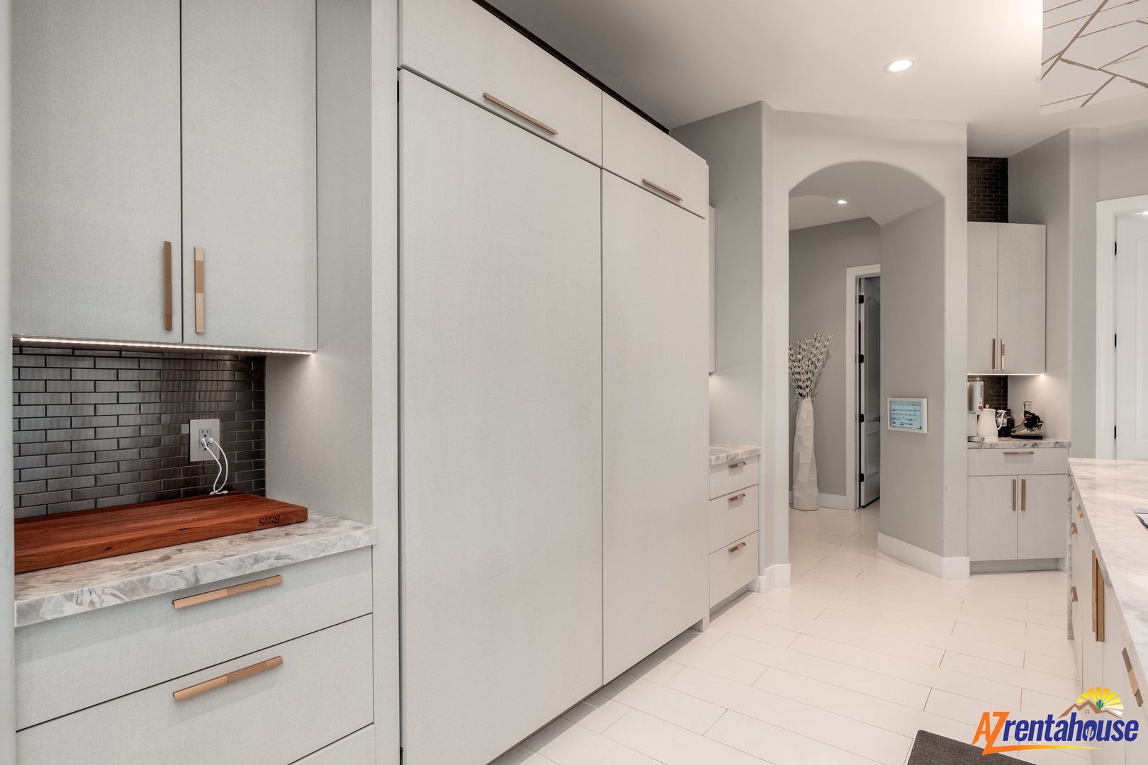 Your gourmet kitchen awaits with sleek white cabinetry, marble countertops, and modern appliances ready for your culinary adventures.