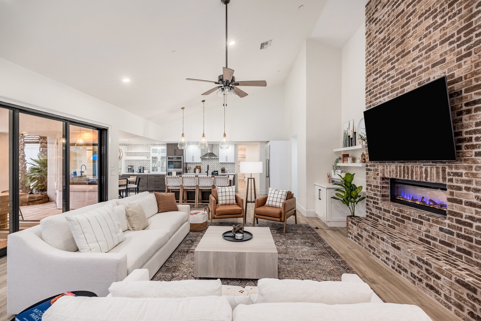 Unwind in your bright, open living space where a cozy fireplace and high ceilings invite you to settle in. Perfect for morning coffee or evening relaxation, this inviting area connects seamlessly to your private outdoor patio.