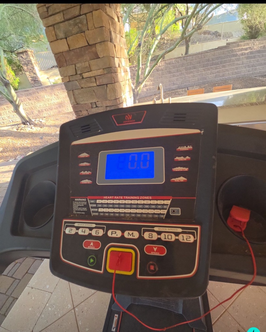 Stay active with your private treadmill on the covered patio, where fitness meets fresh air and peaceful desert surroundings for energizing morning workouts.