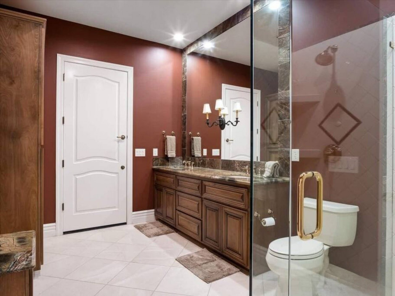 Step into your private bathroom oasis, where rich warm tones and elegant marble accents create a serene, spa-like retreat after your day exploring.