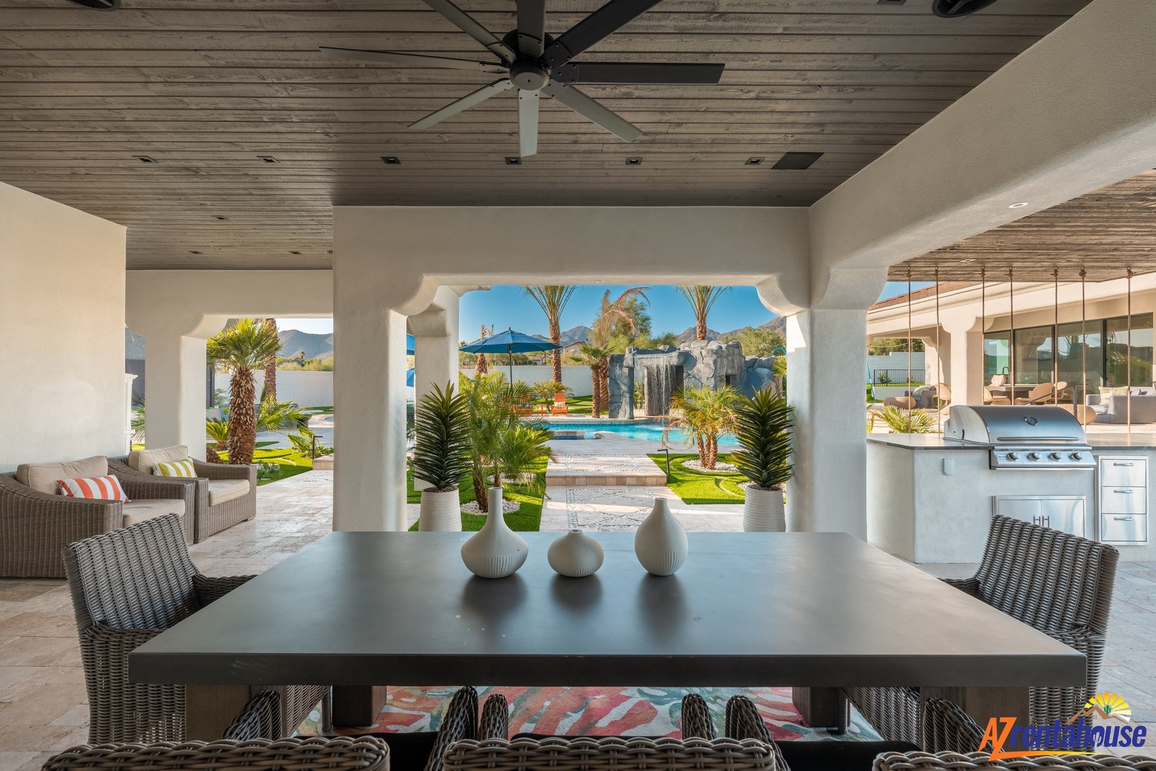 Your elegant outdoor dining space opens to stunning pool views, where tropical palms and modern comfort create your perfect entertaining retreat.