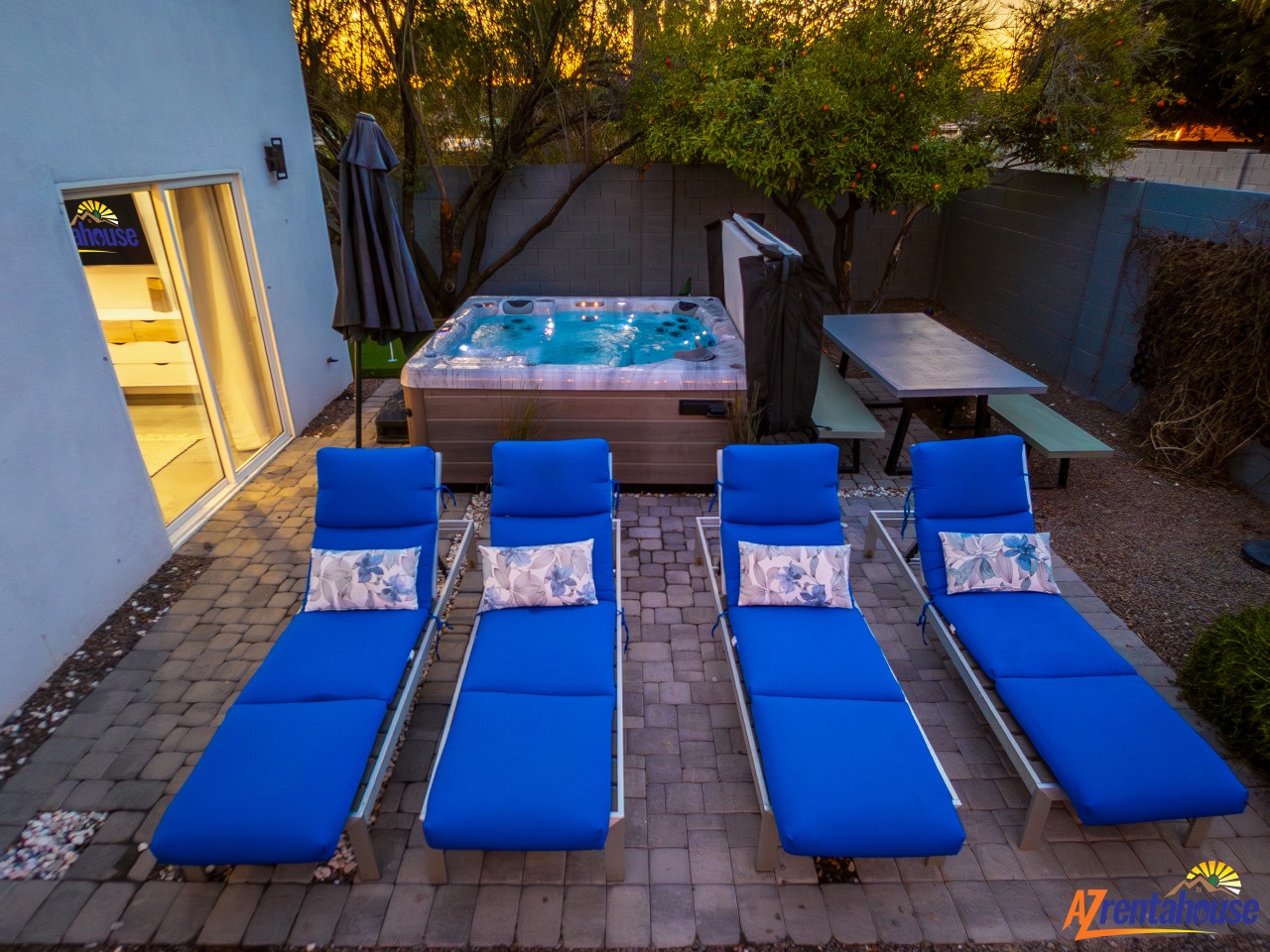 Unwind in your private oasis with a bubbling hot tub and comfortable loungers perfect for evening relaxation.